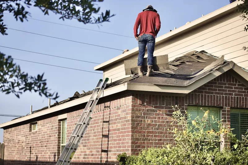 Professional roofer working on a residential roof in Swedesburg